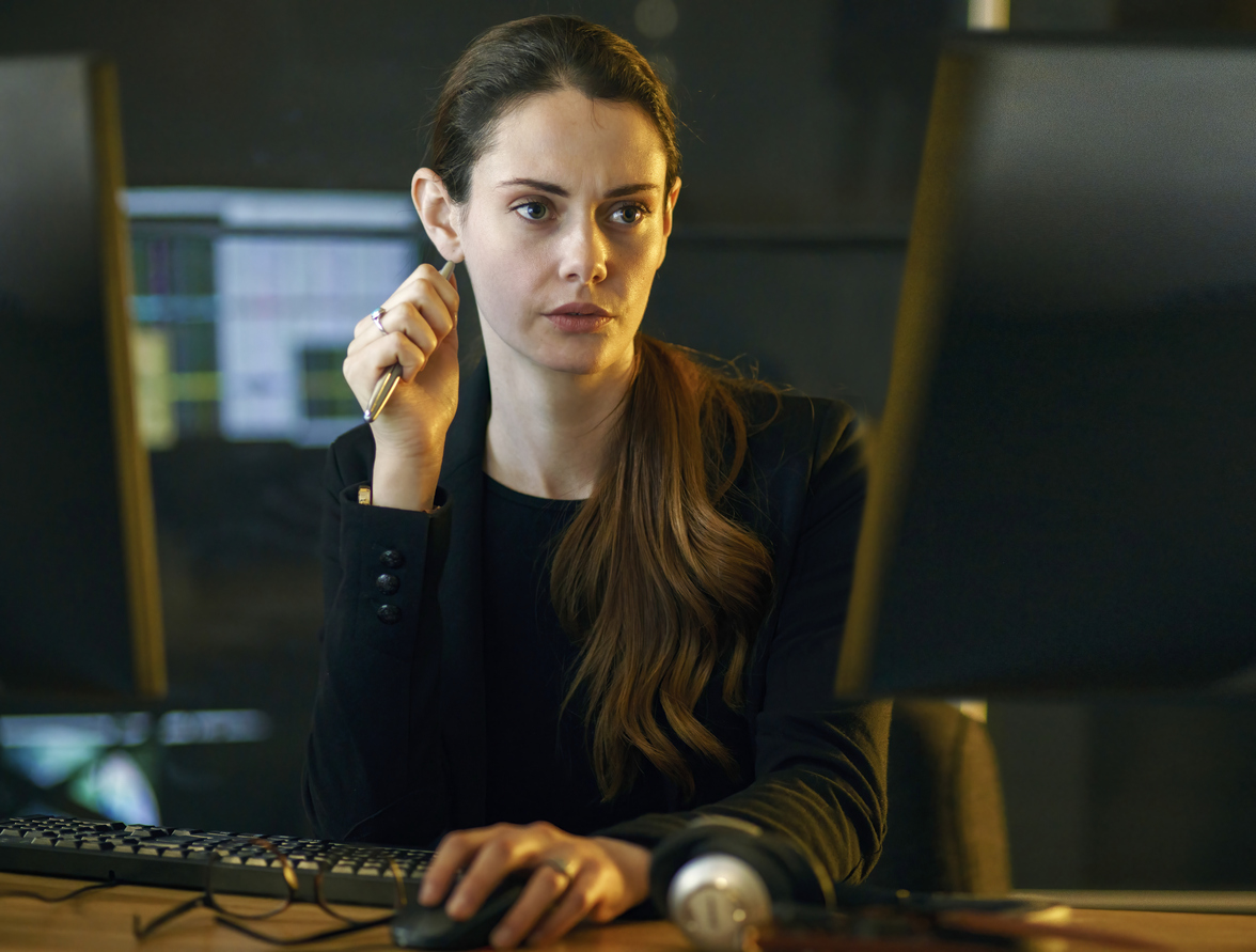 A crime analyst working on a monitor.