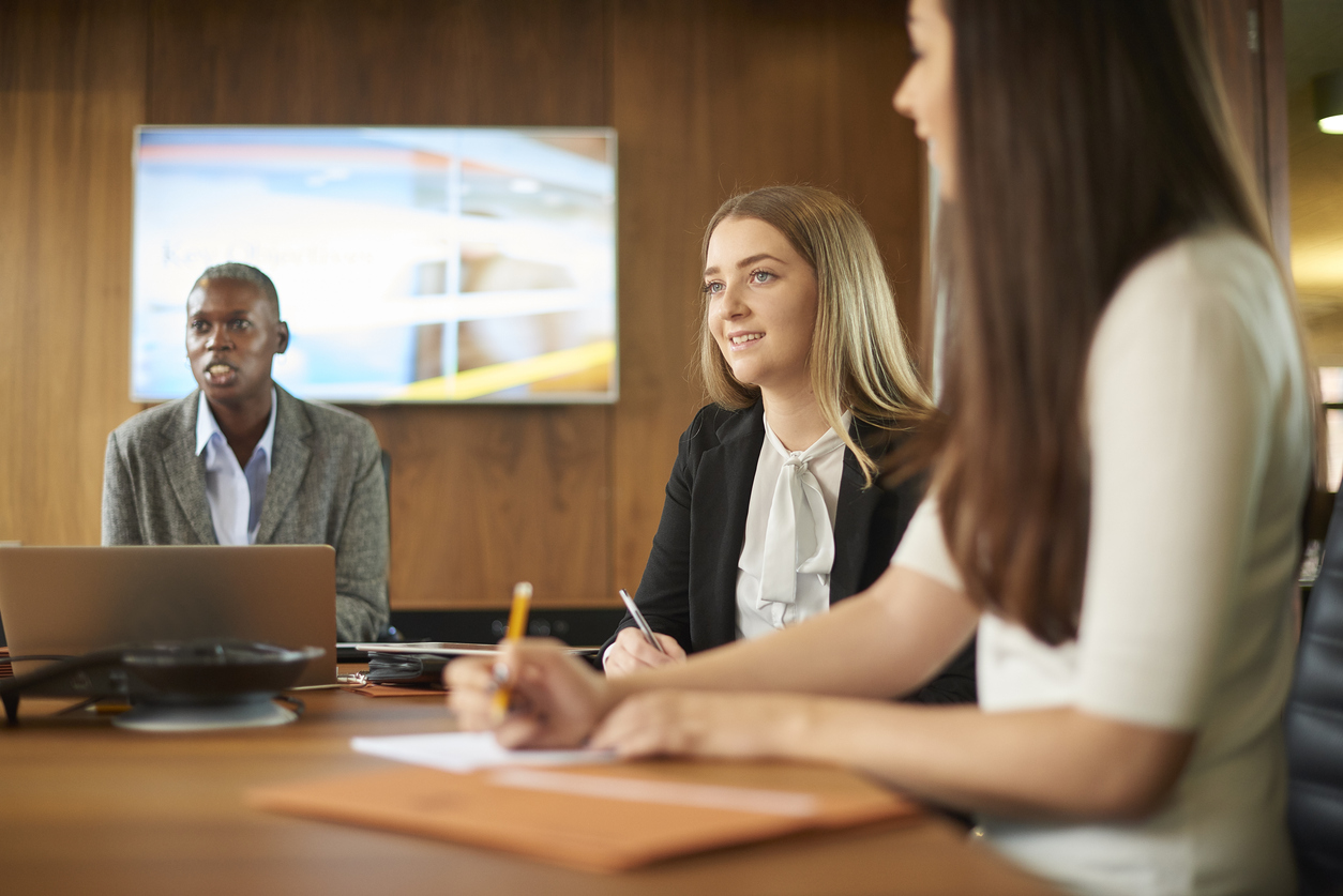 A Paralegal Meeting With a Legal Team in a Conference Room.