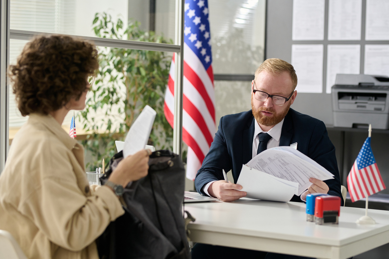 A Foreign Service Officer Helps an Applicant With a Visa Application.