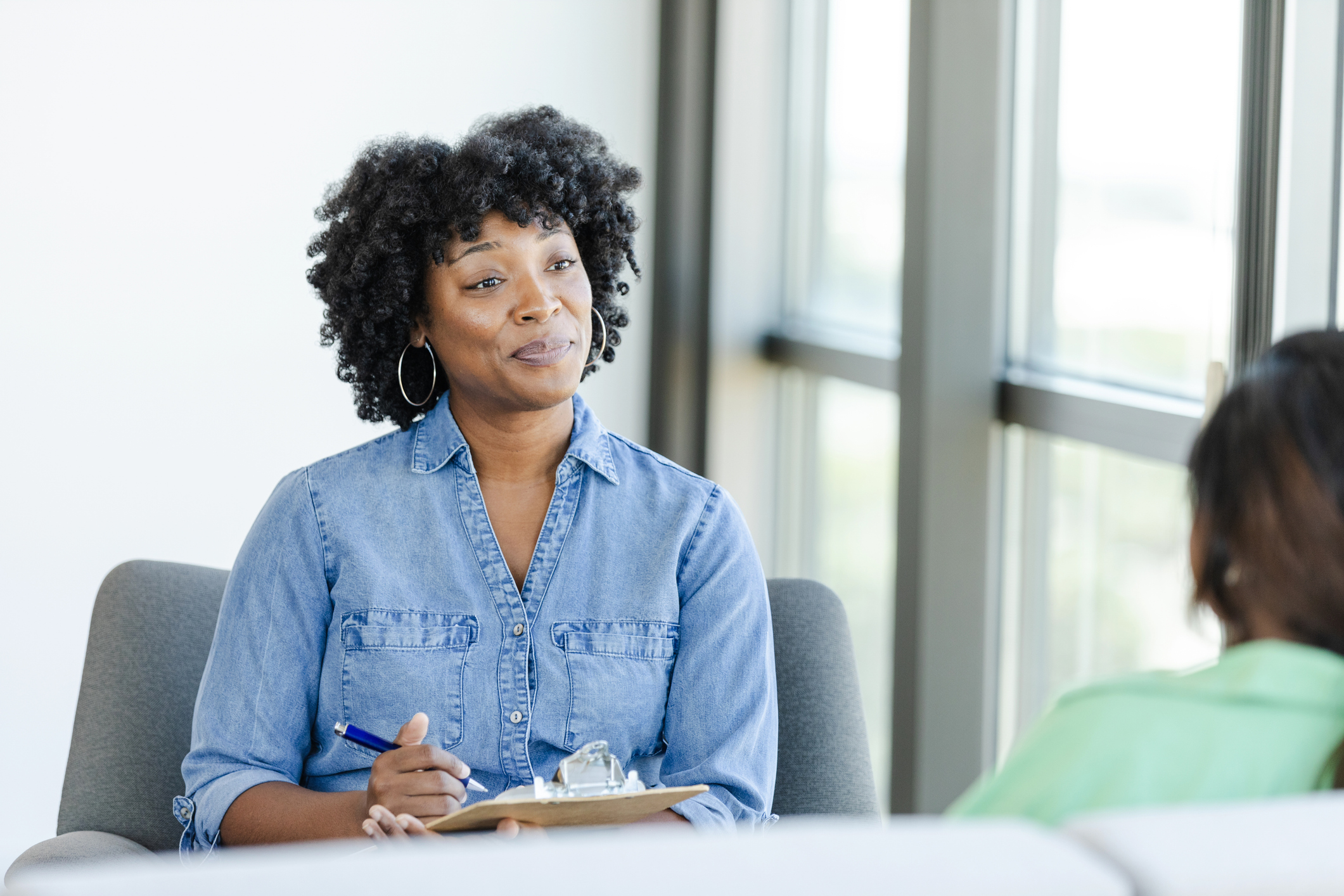 A counselor sitting and listening to a patient. 
