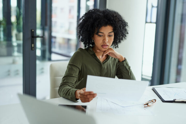 A policy analyst reviews data in an office.