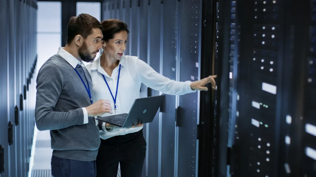 Cybersecurity professionals consulting in a control room.