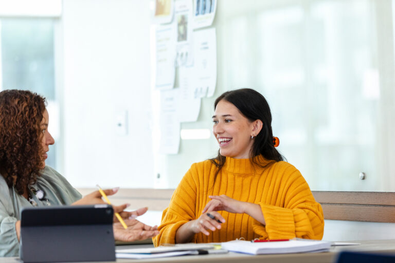 A Professional in an Office Talking With a Colleague
